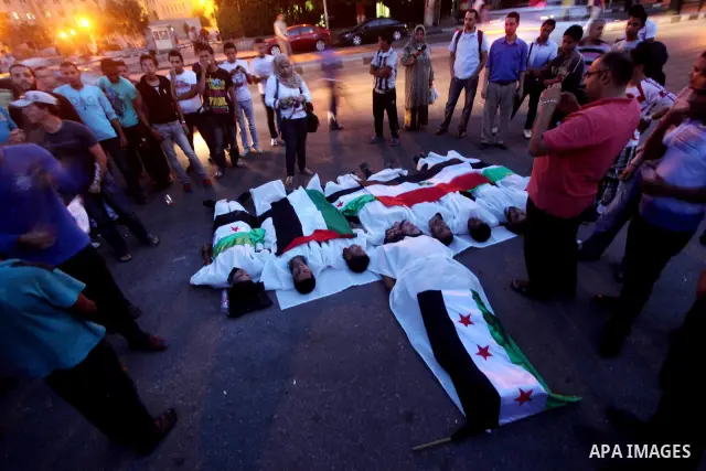 Protesters show solidarity with victims of massacre of Houla during a protest in front of the Syrian embassy in Cairo, Egypt, 31 May 2012. A massacre was reported in the central Syrian city of Houla over the weekend, how...
