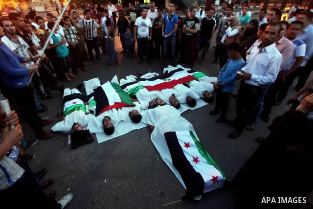 Protesters show solidarity with victims of massacre of Houla during a protest in front of the Syrian embassy in Cairo, Egypt, 31 May 2012. A massacre was reported in the central Syrian city of Houla over the weekend, how...