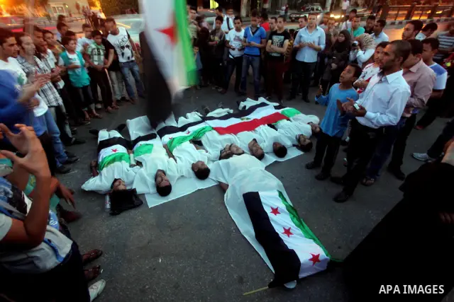Protesters show solidarity with victims of massacre of Houla during a protest in front of the Syrian embassy in Cairo, Egypt, 31 May 2012. A massacre was reported in the central Syrian city of Houla over the weekend, how...