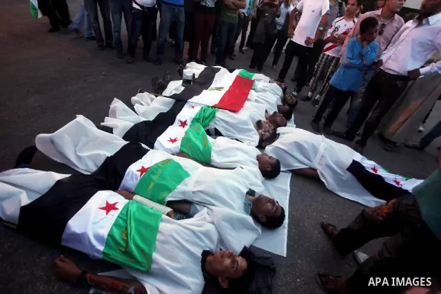 Protesters show solidarity with victims of massacre of Houla during a protest in front of the Syrian embassy in Cairo, Egypt, 31 May 2012. A massacre was reported in the central Syrian city of Houla over the weekend, how...