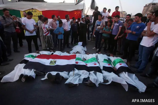 Protesters show solidarity with victims of massacre of Houla during a protest in front of the Syrian embassy in Cairo, Egypt, 31 May 2012. A massacre was reported in the central Syrian city of Houla over the weekend, how...