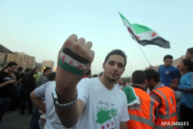 A syrian shows the revolutionary flag on his hand during a protest against the weekend massacre of Houla, in front of the Syrian embassy in Cairo, Egypt, 31 May 2012. A massacre was reported in the central Syrian city of...