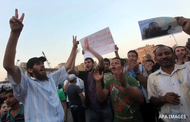Protesters shout slogans as they protest against the weekend massacre of Houla, in front of the Syrian embassy in Cairo, Egypt, 31 May 2012. A massacre was reported in the central Syrian city of Houla over the weekend, h...