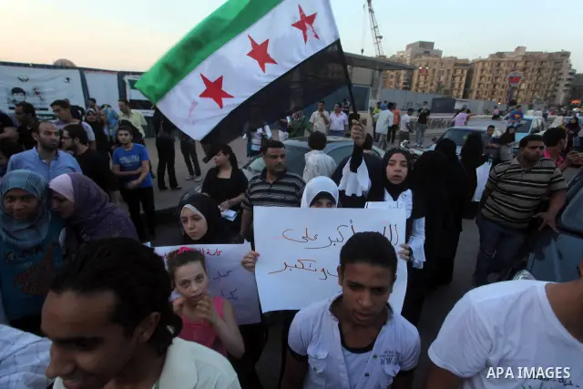Protesters shout slogans as they protest against the weekend massacre of Houla, in front of the Syrian embassy in Cairo, Egypt, 31 May 2012. A massacre was reported in the central Syrian city of Houla over the weekend, h...