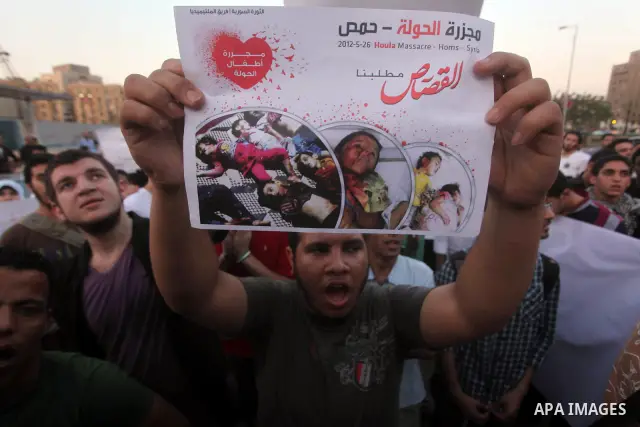 Protesters shout slogans as they protest against the weekend massacre of Houla, in front of the Syrian embassy in Cairo, Egypt, 31 May 2012. A massacre was reported in the central Syrian city of Houla over the weekend, h...