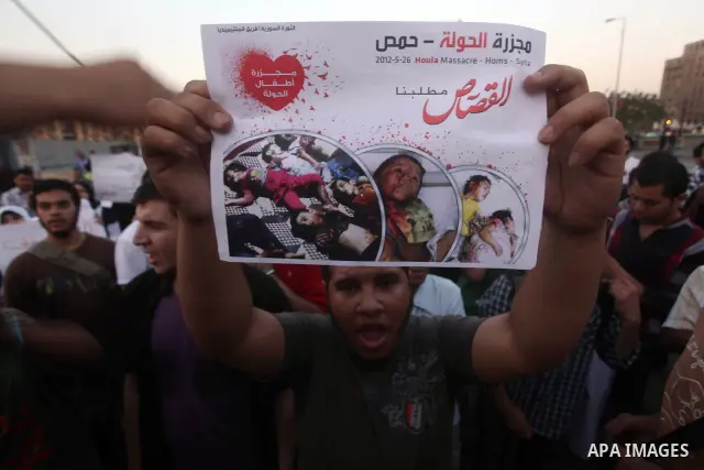 Protesters shout slogans as they protest against the weekend massacre of Houla, in front of the Syrian embassy in Cairo, Egypt, 31 May 2012. A massacre was reported in the central Syrian city of Houla over the weekend, h...