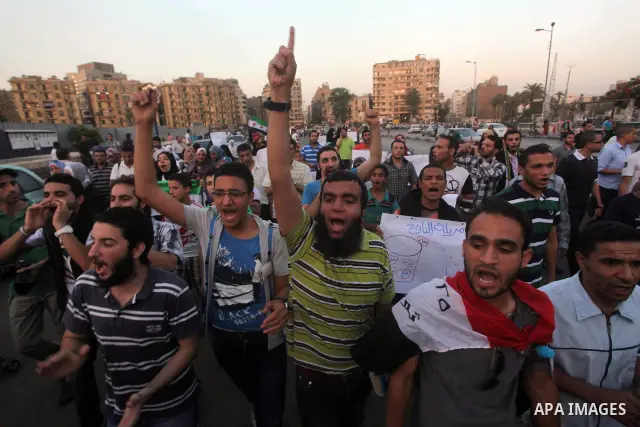 Protesters shout slogans as they protest against the weekend massacre of Houla, in front of the Syrian embassy in Cairo, Egypt, 31 May 2012. A massacre was reported in the central Syrian city of Houla over the weekend, h...
