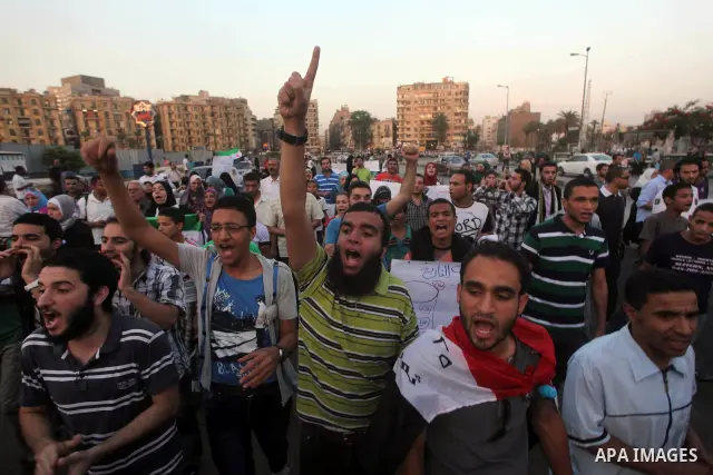 Protesters shout slogans as they protest against the weekend massacre of Houla, in front of the Syrian embassy in Cairo, Egypt, 31 May 2012. A massacre was reported in the central Syrian city of Houla over the weekend, h...