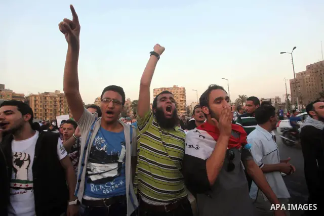 Protesters shout slogans as they protest against the weekend massacre of Houla, in front of the Syrian embassy in Cairo, Egypt, 31 May 2012. A massacre was reported in the central Syrian city of Houla over the weekend, h...
