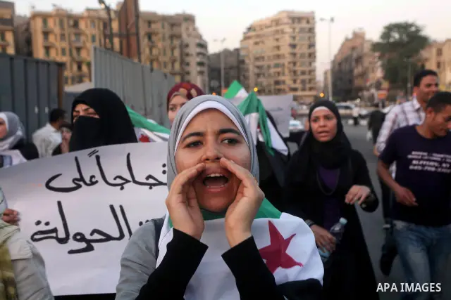Protesters shout slogans as they protest against the weekend massacre of Houla, in front of the Syrian embassy in Cairo, Egypt, 31 May 2012. A massacre was reported in the central Syrian city of Houla over the weekend, h...
