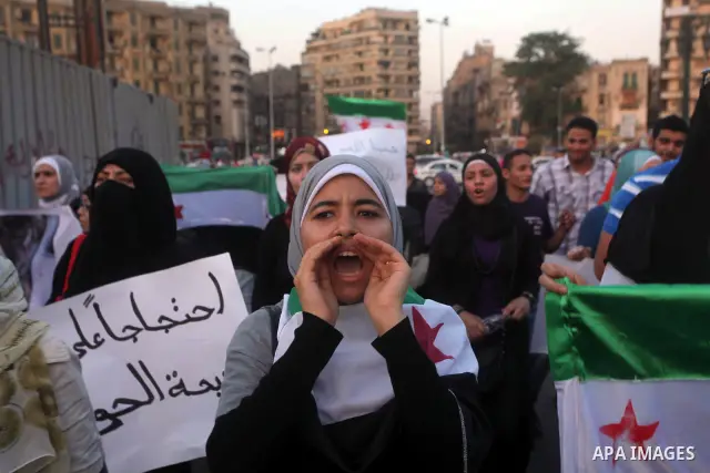Protesters shout slogans as they protest against the weekend massacre of Houla, in front of the Syrian embassy in Cairo, Egypt, 31 May 2012. A massacre was reported in the central Syrian city of Houla over the weekend, h...