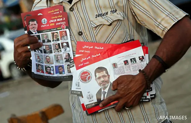Egyptian Protester holds picture of candidate Mohammed Morsi during a protest against candidate Ahmed Shafiq, at Tahrir Square in Cairo May 31, 2012. The prospect of Shafiq succeeding Hosni Mubarak as president of Egypt...