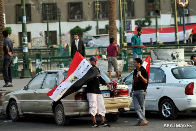 Egyptian Protester waves flag during a protest against candidate Ahmed Shafiq, at Tahrir Square in Cairo May 31, 2012. The prospect of Shafiq succeeding Hosni Mubarak as president of Egypt is a nightmare for revolutionar...