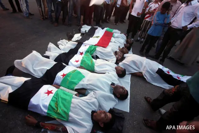 Protesters show solidarity with victims of massacre of Houla during a protest in front of the Syrian embassy in Cairo, Egypt, 31 May 2012. A massacre was reported in the central Syrian city of Houla over the weekend, how...
