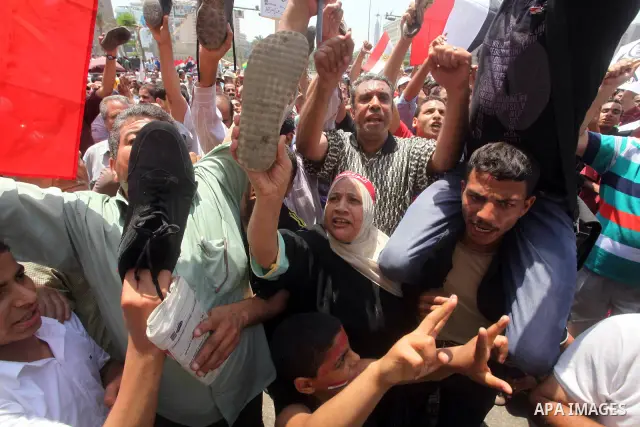 Egyptian protesters hold shoes and shout slogans against the presidential candidate Ahmed Shafik, during a protest in Tahrir Square, Cairo, Egypt, 01 June 2012. Media reports state that hundreds of Egyptians held a demon...
