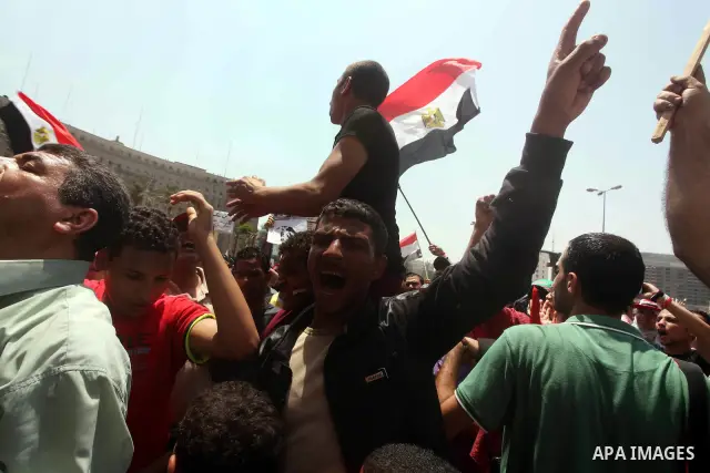 Egyptian protesters hold placards and shout slogans against the presidential candidate Ahmed Shafik, during a protest in Tahrir Square, Cairo, Egypt, 01 June 2012. Media reports state that hundreds of Egyptians held a de...