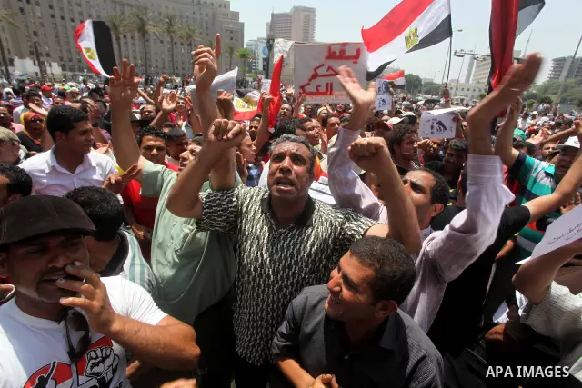Egyptian protesters hold placards and shout slogans against the presidential candidate Ahmed Shafik, during a protest in Tahrir Square, Cairo, Egypt, 01 June 2012. Media reports state that hundreds of Egyptians held a de...