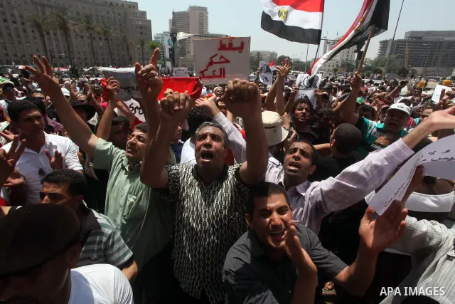 Egyptian protesters hold placards and shout slogans against the presidential candidate Ahmed Shafik, during a protest in Tahrir Square, Cairo, Egypt, 01 June 2012. Media reports state that hundreds of Egyptians held a de...
