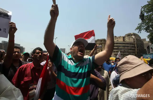 Egyptian protesters hold placards and shout slogans against the presidential candidate Ahmed Shafik, during a protest in Tahrir Square, Cairo, Egypt, 01 June 2012. Media reports state that hundreds of Egyptians held a de...