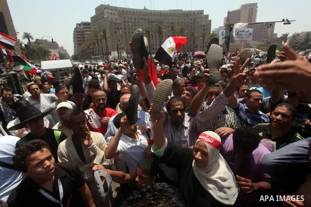 Egyptian protesters hold shoes and shout slogans against the presidential candidate Ahmed Shafik, during a protest in Tahrir Square, Cairo, Egypt, 01 June 2012. Media reports state that hundreds of Egyptians held a demon...