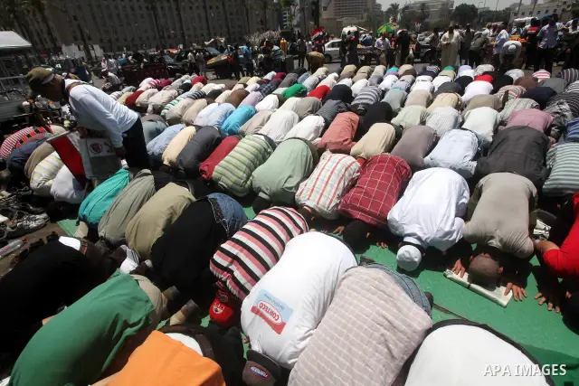 Egyptian protesters perform the weekly Friday noon prayer in Cairo's landmark Tahrir square during a demonstration against Egyptian presidential runoff candidate Ahmed Shafiq, an ex-prime minister under the ousted regime...