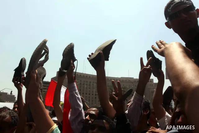 Egyptian protesters hold shoes and shout slogans against the presidential candidate Ahmed Shafik, during a protest in Tahrir Square, Cairo, Egypt, 01 June 2012. Media reports state that hundreds of Egyptians held a demon...