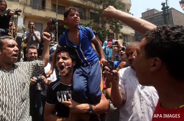 Egyptian protesters hold placards and shout slogans against the presidential candidate Ahmed Shafik, during a protest in Tahrir Square, Cairo, Egypt, 01 June 2012. Media reports state that hundreds of Egyptians held a de...