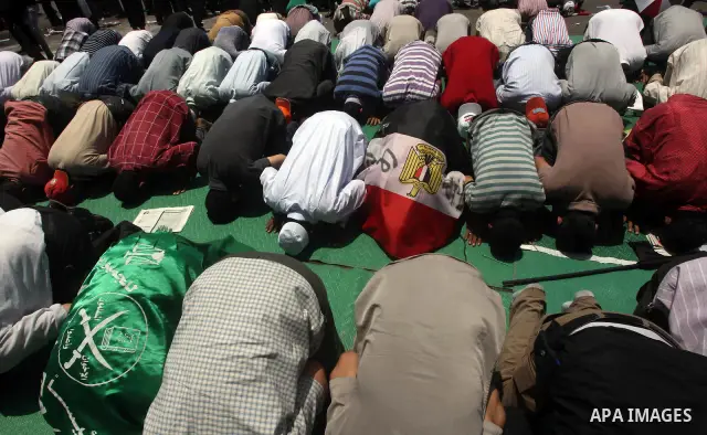 Egyptian protesters perform the weekly Friday noon prayer in Cairo's landmark Tahrir square during a demonstration against Egyptian presidential runoff candidate Ahmed Shafiq, an ex-prime minister under the ousted regime...