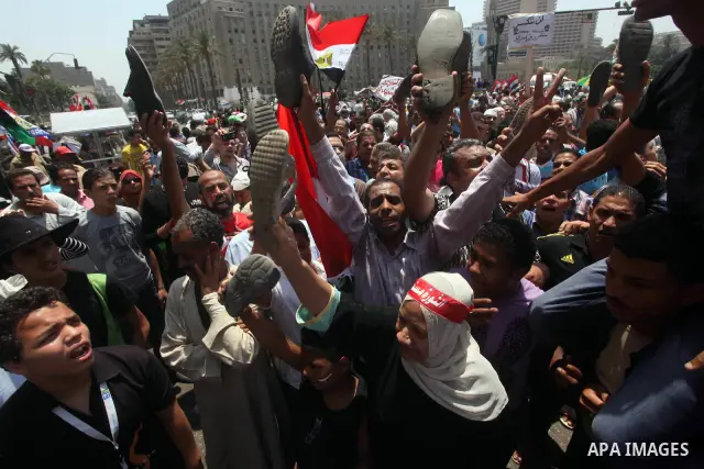 Egyptian protesters hold shoes and shout slogans against the presidential candidate Ahmed Shafik, during a protest in Tahrir Square, Cairo, Egypt, 01 June 2012. Media reports state that hundreds of Egyptians held a demon...
