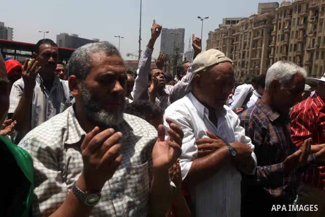 Egyptian protesters perform the weekly Friday noon prayer in Cairo's landmark Tahrir square during a demonstration against Egyptian presidential runoff candidate Ahmed Shafiq, an ex-prime minister under the ousted regime...