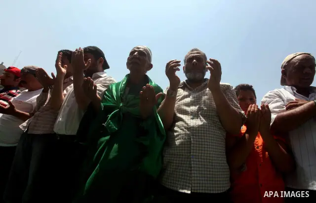 Egyptian protesters perform the weekly Friday noon prayer in Cairo's landmark Tahrir square during a demonstration against Egyptian presidential runoff candidate Ahmed Shafiq, an ex-prime minister under the ousted regime...