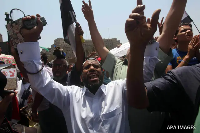 Egyptian protesters hold placards and shout slogans against the presidential candidate Ahmed Shafik, during a protest in Tahrir Square, Cairo, Egypt, 01 June 2012. Media reports state that hundreds of Egyptians held a de...