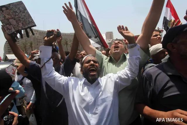 Egyptian protesters hold placards and shout slogans against the presidential candidate Ahmed Shafik, during a protest in Tahrir Square, Cairo, Egypt, 01 June 2012. Media reports state that hundreds of Egyptians held a de...