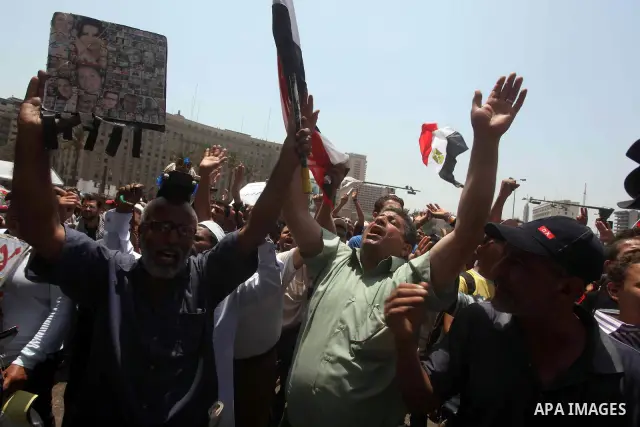 Egyptian protesters hold placards and shout slogans against the presidential candidate Ahmed Shafik, during a protest in Tahrir Square, Cairo, Egypt, 01 June 2012. Media reports state that hundreds of Egyptians held a de...