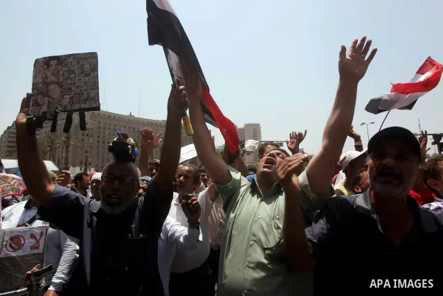 Egyptian protesters hold placards and shout slogans against the presidential candidate Ahmed Shafik, during a protest in Tahrir Square, Cairo, Egypt, 01 June 2012. Media reports state that hundreds of Egyptians held a de...