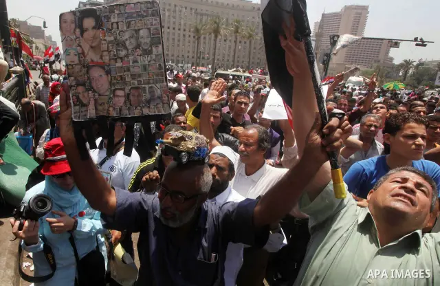 Egyptian protesters hold placards and shout slogans against the presidential candidate Ahmed Shafik, during a protest in Tahrir Square, Cairo, Egypt, 01 June 2012. Media reports state that hundreds of Egyptians held a de...