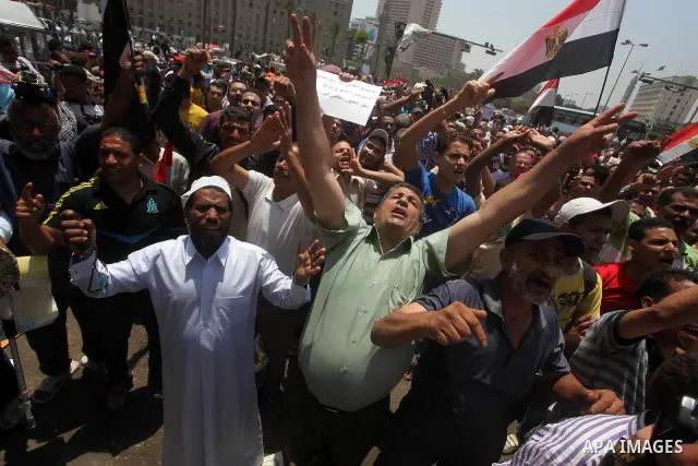 Egyptian protesters hold placards and shout slogans against the presidential candidate Ahmed Shafik, during a protest in Tahrir Square, Cairo, Egypt, 01 June 2012. Media reports state that hundreds of Egyptians held a de...