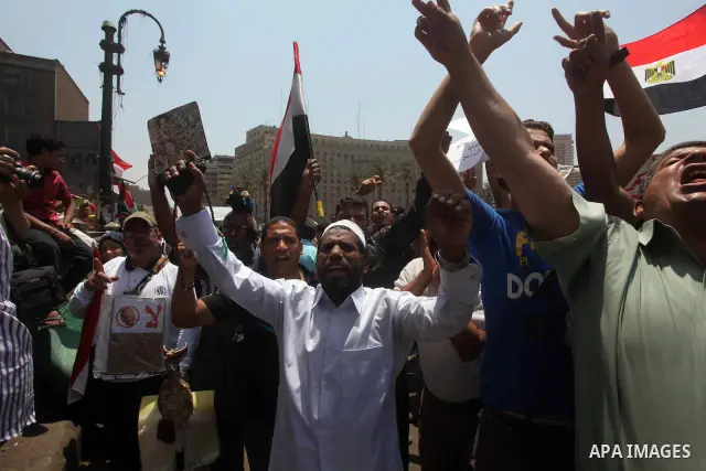 Egyptian protesters hold placards and shout slogans against the presidential candidate Ahmed Shafik, during a protest in Tahrir Square, Cairo, Egypt, 01 June 2012. Media reports state that hundreds of Egyptians held a de...