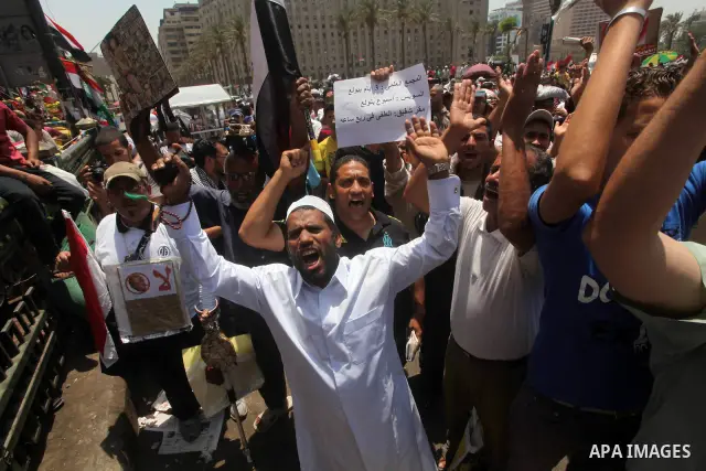 Egyptian protesters hold placards and shout slogans against the presidential candidate Ahmed Shafik, during a protest in Tahrir Square, Cairo, Egypt, 01 June 2012. Media reports state that hundreds of Egyptians held a de...