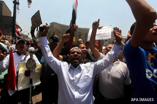 Egyptian protesters hold placards and shout slogans against the presidential candidate Ahmed Shafik, during a protest in Tahrir Square, Cairo, Egypt, 01 June 2012. Media reports state that hundreds of Egyptians held a de...