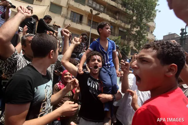 Egyptian protesters hold placards and shout slogans against the presidential candidate Ahmed Shafik, during a protest in Tahrir Square, Cairo, Egypt, 01 June 2012. Media reports state that hundreds of Egyptians held a de...