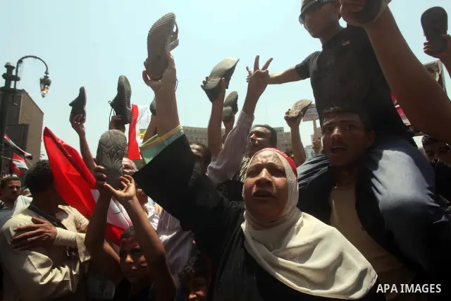 Egyptian protesters hold shoes and shout slogans against the presidential candidate Ahmed Shafik, during a protest in Tahrir Square, Cairo, Egypt, 01 June 2012. Media reports state that hundreds of Egyptians held a demon...
