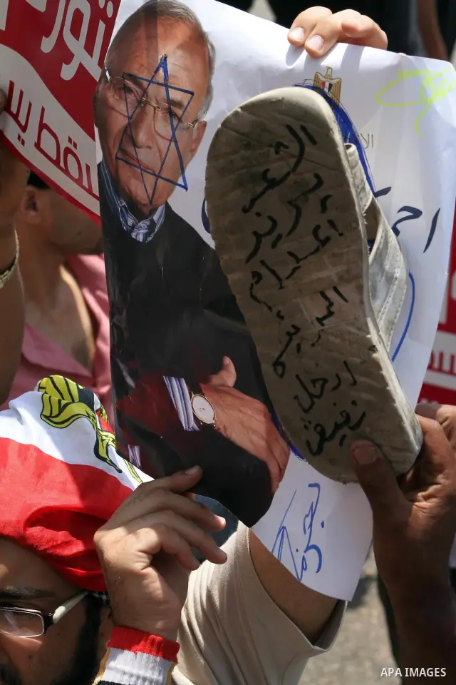 Egyptian protesters hold shoes and shout slogans against the presidential candidate Ahmed Shafik, during a protest in Tahrir Square, Cairo, Egypt, 01 June 2012. Media reports state that hundreds of Egyptians held a demon...