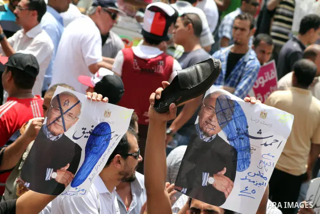 Egyptian protesters hold shoes and shout slogans against the presidential candidate Ahmed Shafik, during a protest in Tahrir Square, Cairo, Egypt, 01 June 2012. Media reports state that hundreds of Egyptians held a demon...