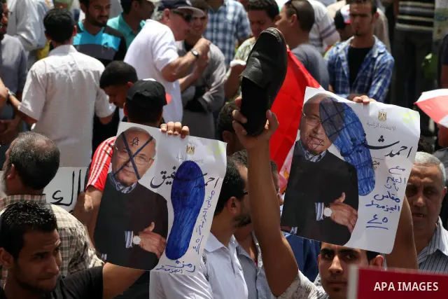 Egyptian protesters hold placards and shout slogans against the presidential candidate Ahmed Shafik, during a protest in Tahrir Square, Cairo, Egypt, 01 June 2012. Media reports state that hundreds of Egyptians held a de...