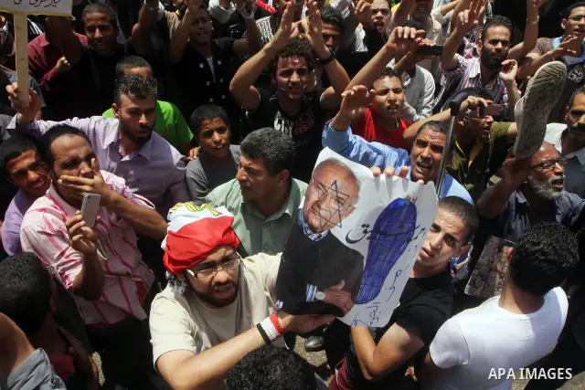 Egyptian protesters hold placards and shout slogans against the presidential candidate Ahmed Shafik, during a protest in Tahrir Square, Cairo, Egypt, 01 June 2012. Media reports state that hundreds of Egyptians held a de...
