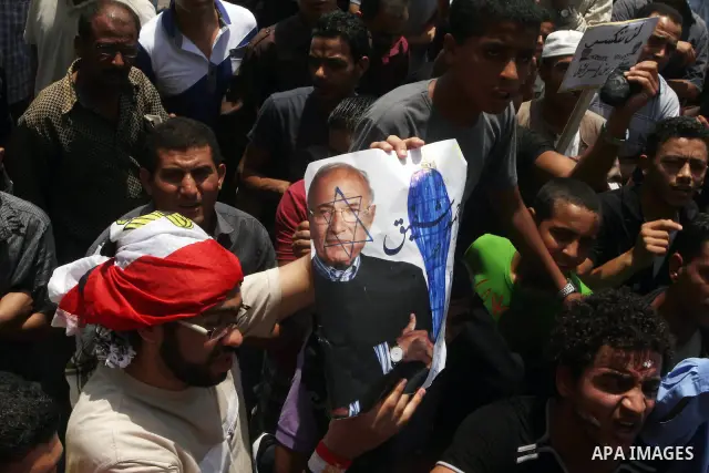 Egyptian protesters hold placards and shout slogans against the presidential candidate Ahmed Shafik, during a protest in Tahrir Square, Cairo, Egypt, 01 June 2012. Media reports state that hundreds of Egyptians held a de...