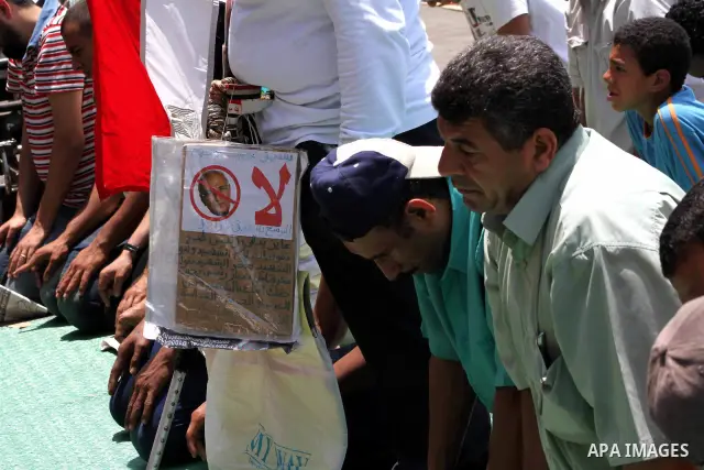 Egyptian protesters perform the weekly Friday noon prayer in Cairo's landmark Tahrir square during a demonstration against Egyptian presidential runoff candidate Ahmed Shafiq, an ex-prime minister under the ousted regime...