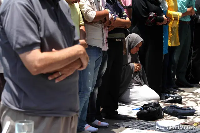 Egyptian protesters perform the weekly Friday noon prayer in Cairo's landmark Tahrir square during a demonstration against Egyptian presidential runoff candidate Ahmed Shafiq, an ex-prime minister under the ousted regime...