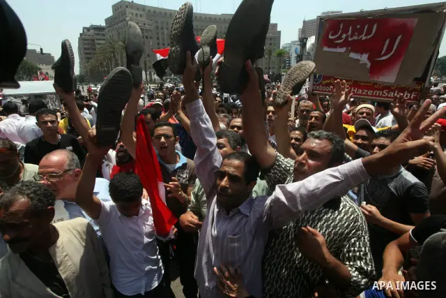 Egyptian protesters hold shoes and shout slogans against the presidential candidate Ahmed Shafik, during a protest in Tahrir Square, Cairo, Egypt, 01 June 2012. Media reports state that hundreds of Egyptians held a demon...